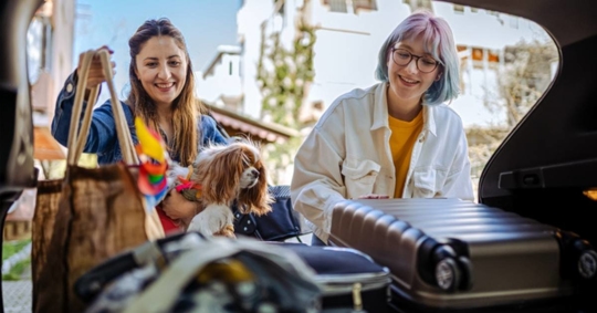 young family and their dog returning home after travel